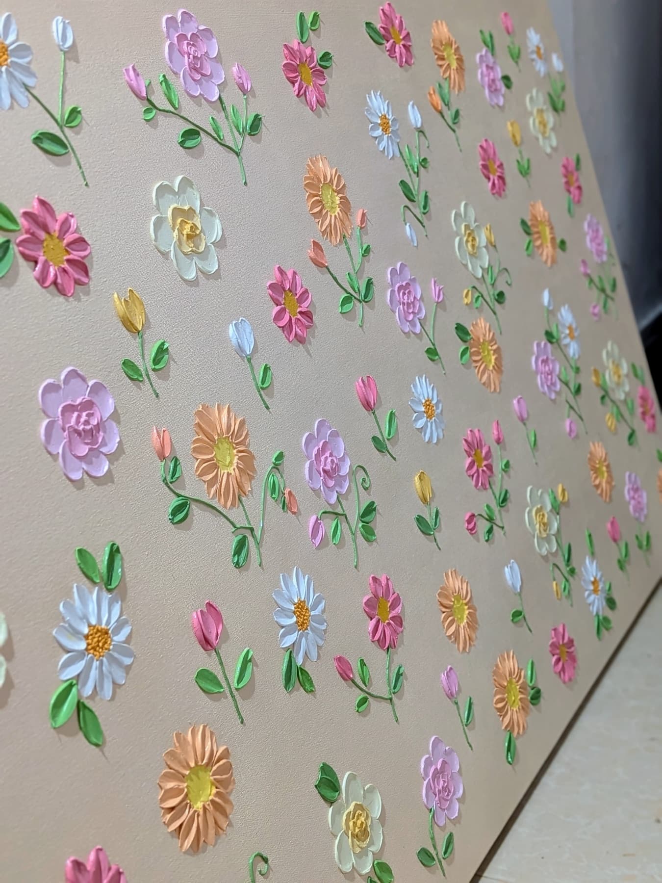 Close-up of sculpted pastel flowers on a textured canvas by Mal
